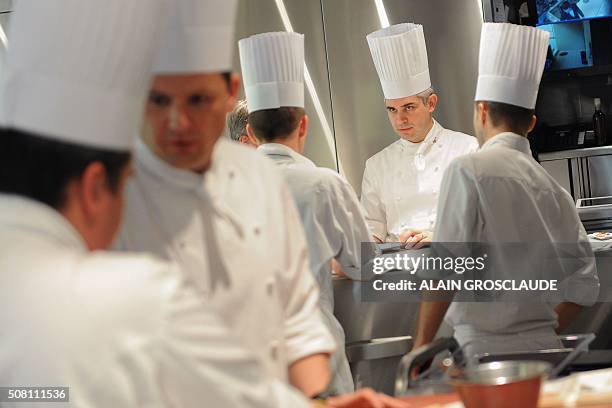This picture taken on May 19, 2012 shows late top chef Benoit Violier and his brigade working at the Restaurant de l'Hotel de Ville in Crissier near...