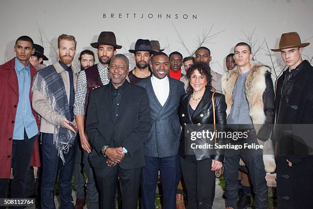 Father Bob Johnson, designer Brett Johnson and mother Sheila Johnson pose with the models at the Brett Johnson Presentation during New York Fashion...