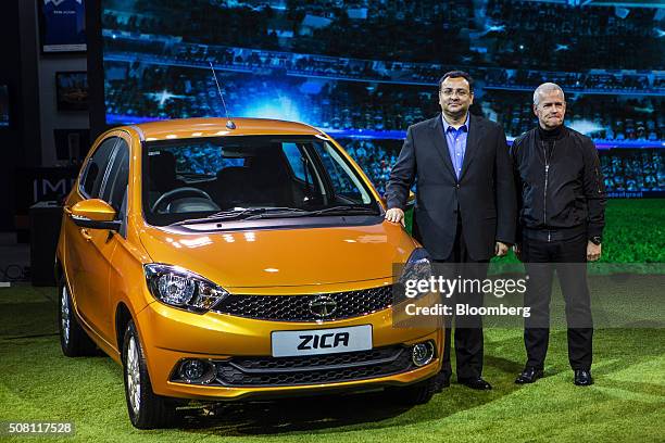 Cyrus Mistry, chairman of Tata Group, left, poses with the Tata Motors Ltd. Zica hatchback vehicle at the Auto Expo 2016 in Noida, Uttar Pradesh,...