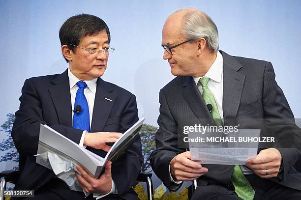 Michel Demare , Chairman of Swiss farm chemicals giant Syngenta speaks to Chinese Ren Jianxin, Chairman of ChemChina during a press conference to...