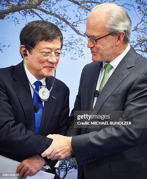 Michel Demare , Chairman of Swiss farm chemicals giant Syngenta shakes hand with Chinese Ren Jianxin, Chairman of ChemChina during a press conference...