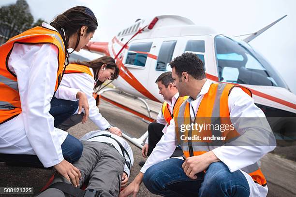 paramedics on an air ambulance - helicopter rescue stock pictures, royalty-free photos & images