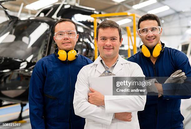 mechanics fixing a helicopter - inside helicopter stock pictures, royalty-free photos & images