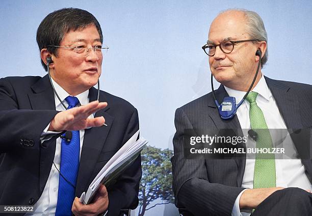 Chinese Ren Jianxin , Chairman of ChemChina gestures next to Michel Demare, Chairman of Swiss farm chemicals giant Syngenta during a press conference...