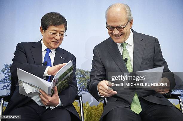 Michel Demare , Chairman of Swiss farm chemicals giant Syngenta laughs next to Chinese Ren Jianxin, Chairman of ChemChina during a press conference...