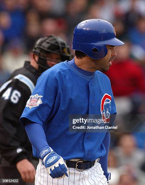 Todd Walker of the Chicago Cubs glares at pitcher Shawn Estes of the Colorado Rockies after being hit by a pitch in the second inning as home plate...