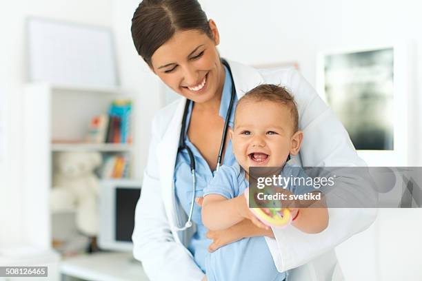 cute baby boy at doctor's office. - doctor and baby stock pictures, royalty-free photos & images