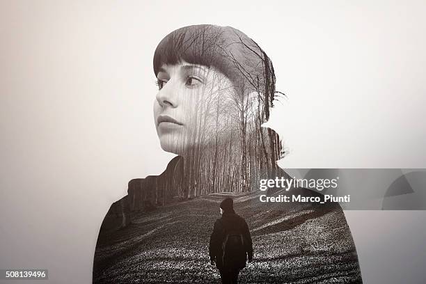 melancholic girl looking into the future - dubbelopname stockfoto's en -beelden