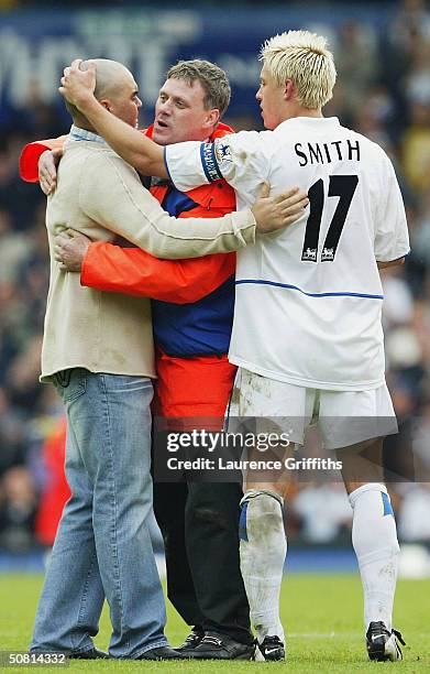 Alan Smith of Leeds consoles a tearfull fan as his side are relagated during the FA Barclaycard Premiership match between Leeds United and Charlton...