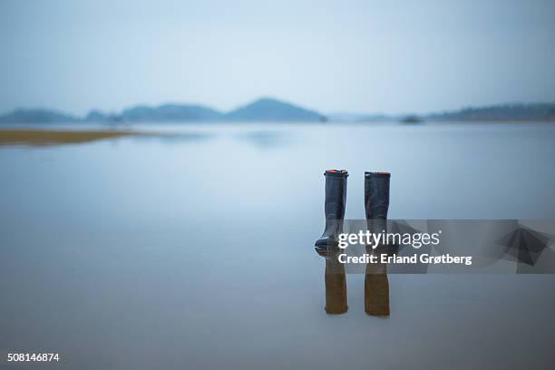 left behind rubber boots - wellington boots stock pictures, royalty-free photos & images