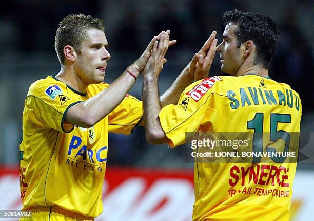 Nantes' Defender Sylvain Armand congratulates his teammate Nicolas Savignaud during their French L1 football match against Toulouse, 08 May 2004 in...