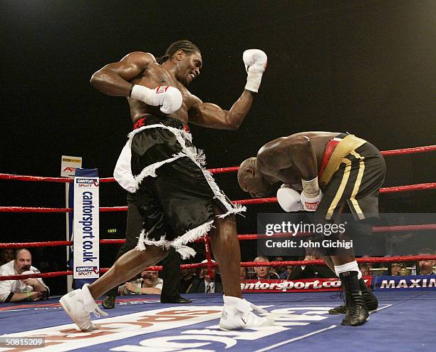 Audley Harrison swings an uppercut as Julius Francis ducks out of the way during their bout on May 8, 2004 at Whitchurch Sports Centre in Bristol,...