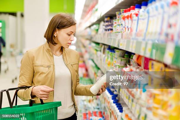 woman buys a milk - labelling stock pictures, royalty-free photos & images