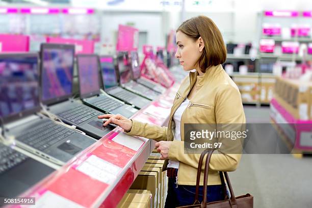 pretty lady in retail computer store - electrical shop stock pictures, royalty-free photos & images