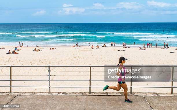 running at bondi beach - bondi beach sand stock pictures, royalty-free photos & images