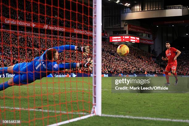 Emre Can of Liverpool watches as his penalty hits the post in the shoot-out during the Capital One Cup Semi-Final Second Leg match between Liverpool...