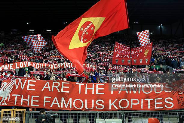 Liverpool fans wave their flags, scarves and banners as they sing 'You'll Never Walk Alone' before the Capital One Cup Semi-Final Second Leg match...