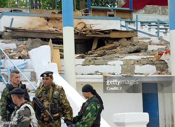 Members of the Chechen police forces guard the site of the explosion that rocked a Grozny stadium, 09 May 2004 during celebrations for Victory Day....