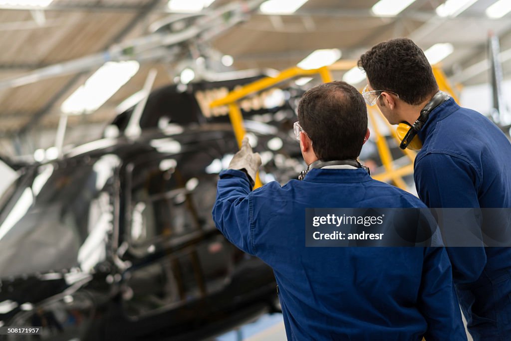 Mechanics fixing a helicopter