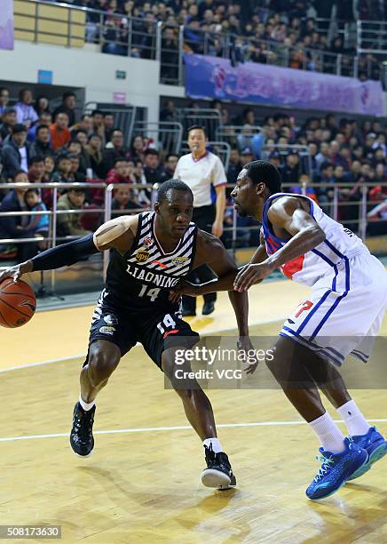 Jordan Crawford of Tianjin Gold Lions defends against Lester Hudson of Liaoning Flying Leopards during the 37th round of the Chinese Basketball...