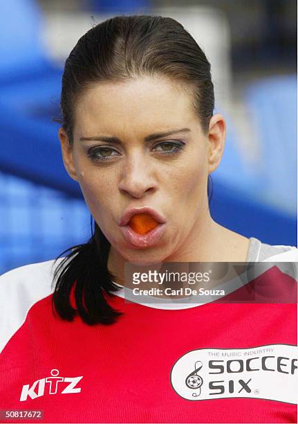 Page 3 Model Lindsey Dawn McKenzie eats an orange at annual "Music Industry Soccer Six" fundraising tournament at Everton's Goodison Park on May 9,...