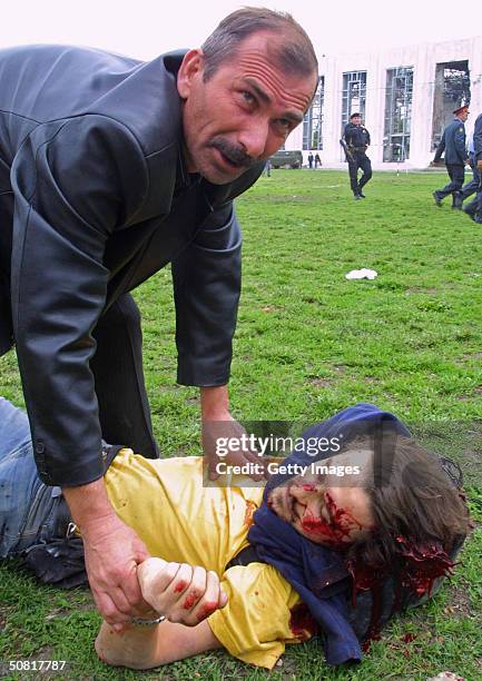 Paramedic tries to help Reuters news agency journalist Adlan Khasanov, who was fatally wounded in a blast during Victory Day celebrations May 9, 2004...