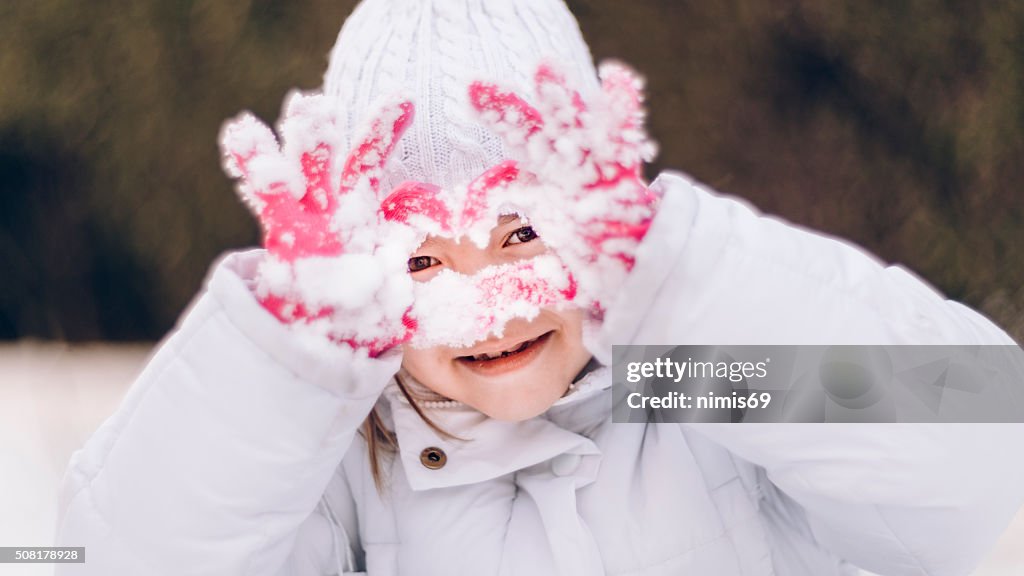 Girl (6-7) Playing in The Snow