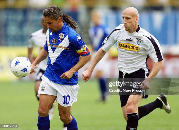 Brescia's Roberto Baggio shields the ball from Lazio's Jaap Stam during the Italian Serie A match between Brescia and SS Lazio at the Mario Rigamonti...