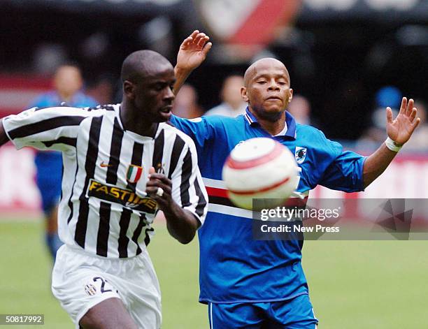 Job of Sampdoria clashes with Stephan Appiah of Juventus during the Serie A match between Juventus and Sampdoria played at the Delle Alpi stadium on...