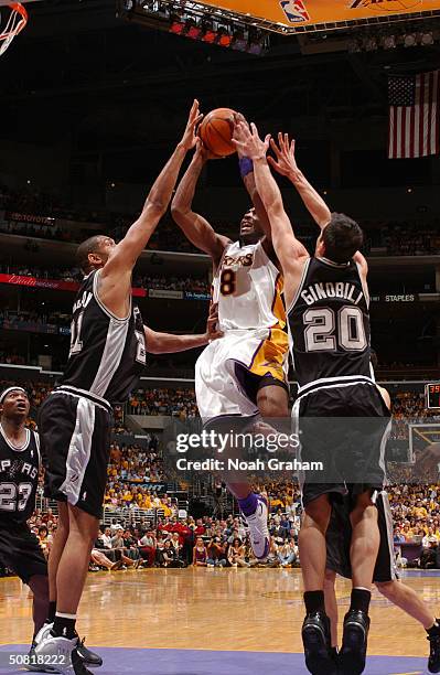 Kobe Bryant of the Los Angeles Lakers attempts a shot against Tim Duncan and Emanuel Ginobili of the San Antonio Spurs in Game three of the Western...