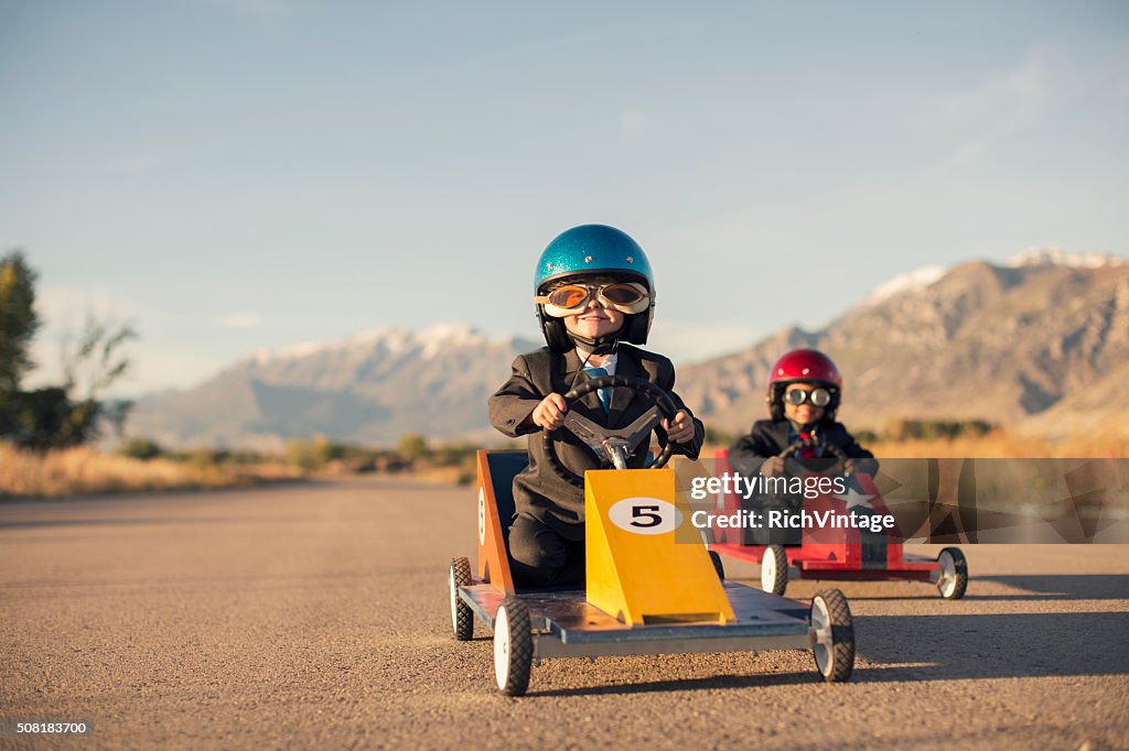 Young Business Boys in Suits Race Toy Cars