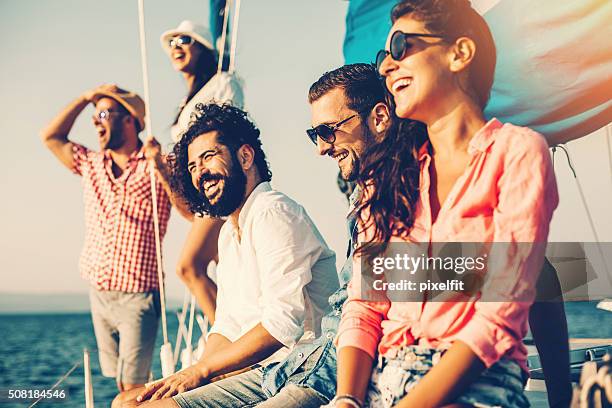 happy friends on a yacht - group sea stockfoto's en -beelden