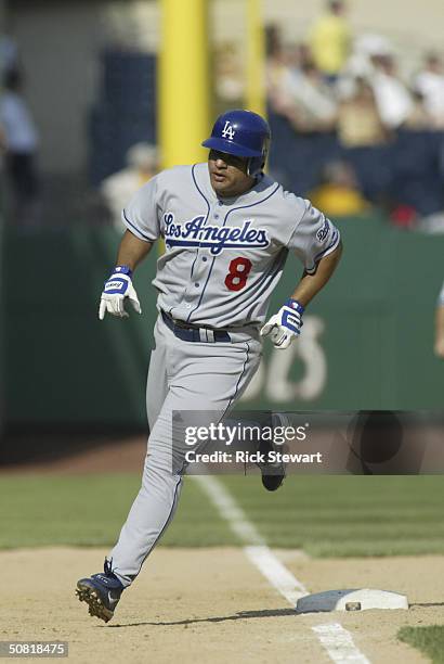 Olmedo Saenz of the Los Angeles Dodgers rounds third base after hitting a game winning two run home run in the 14th inning against the Pittsburgh...