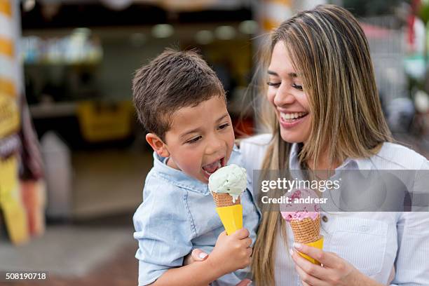 mother and son eating an ice cream - ice cream scoop stock pictures, royalty-free photos & images