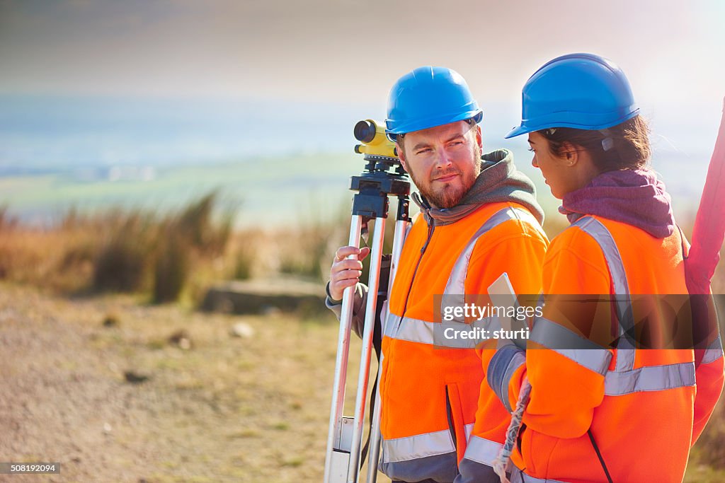 Two construction site surveyors