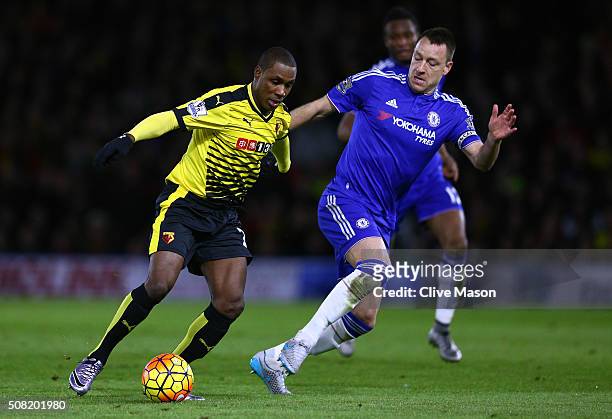 Odion Ighalo of Watford is challenged by John Terry of Chelsea during the Barclays Premier League match between Watford and Chelsea at Vicarage Road...