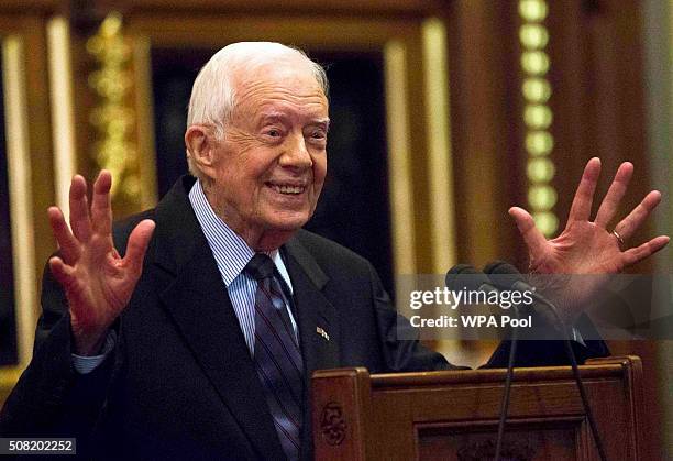 Former U.S. President Jimmy Carter receives applause after delivering a lecture on the eradication of the Guinea worm, at the House of Lords on...