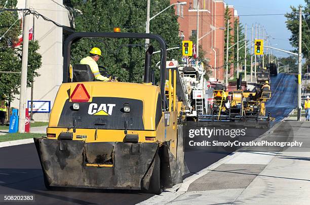 street paving crew - asphalt paving machine stock pictures, royalty-free photos & images