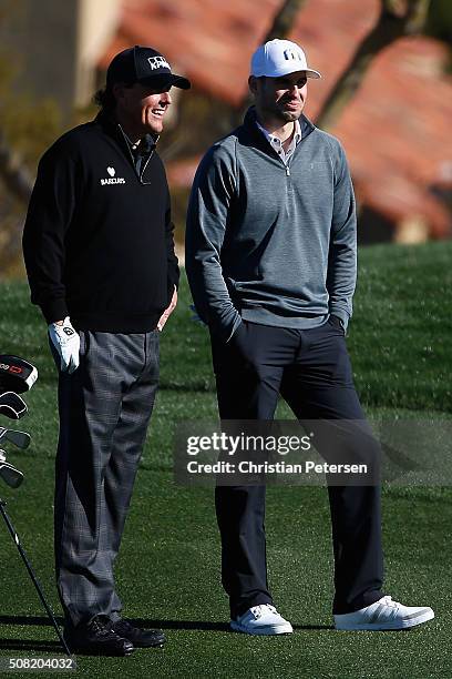 Quarterback Christian Ponder talks with Phil Mickelson on the second hole during the pro-am for the the Waste Management Phoenix Open at TPC...