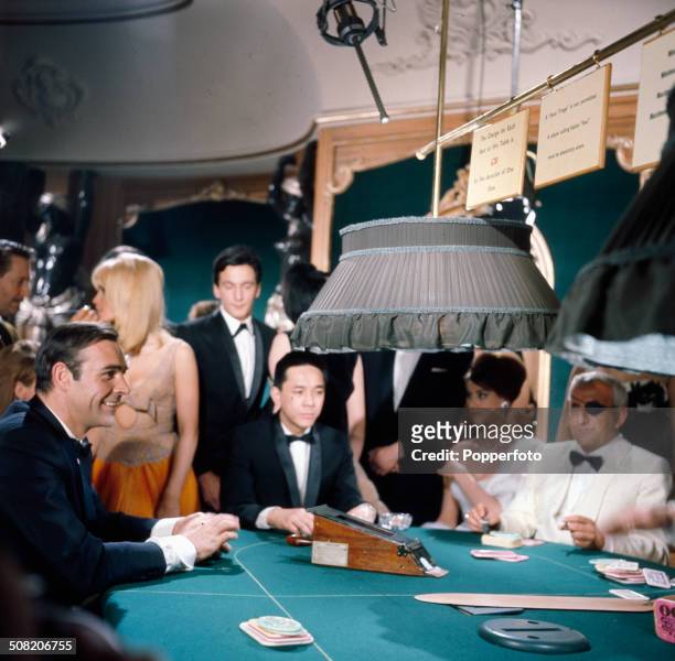 Scottish actor Sean Connery as James Bond and Italian actor Adolfo Celi as eye patch wearing Emilio Largo pictured together in a casino scene from...