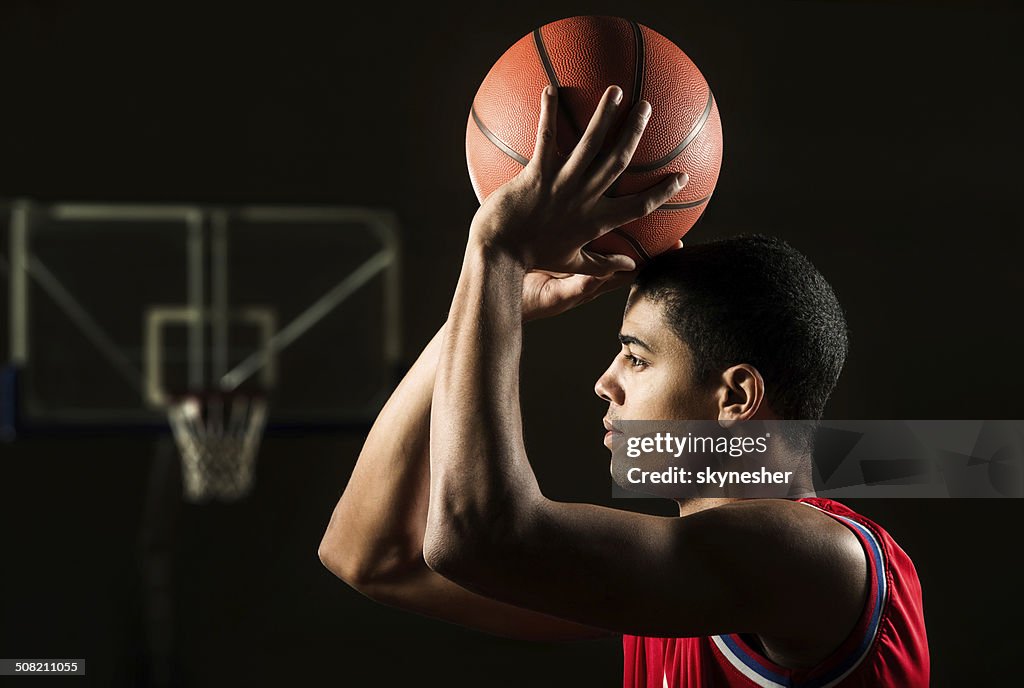 African American man shooting at the hoop.