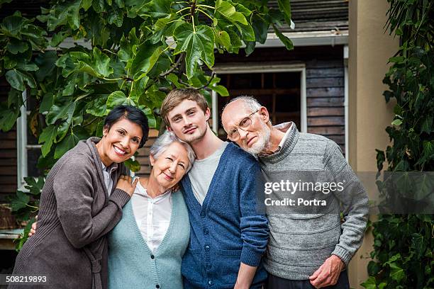 multi-generation family standing together in yard - grandma son stock pictures, royalty-free photos & images