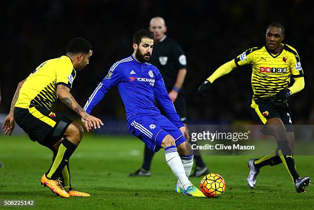 Cesc Fabregas of Chelsea passes as Troy Deeney of Watford and Odion Ighalo of Watford close in during the Barclays Premier League match between...