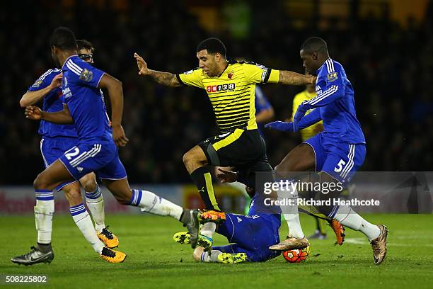 Troy Deeney of Watford is tackled by Cesc Fabregas of Chelsea during the Barclays Premier League match between Watford and Chelsea at Vicarage Road...