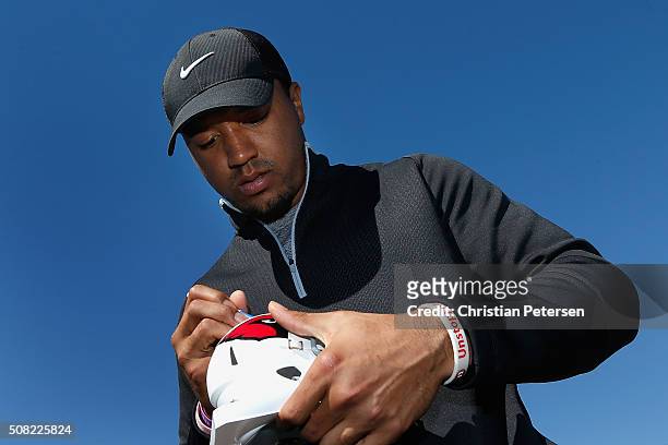 Arizona Cardinals wide receiver Michael Floyd signs an autograph for fans on the 18th green following the pro-am for the the Waste Management Phoenix...