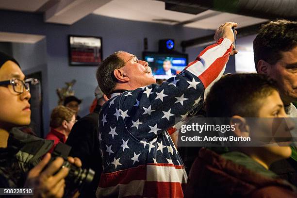 An audience member tries to take a photo of Republican presidential hopeful Sen. Ted Cruz at a campaign event at The Village Trestle restaurant on...