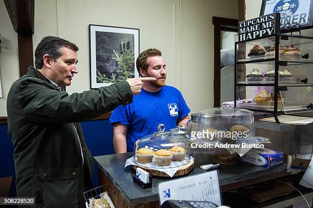 Republican presidential hopeful Sen. Ted Cruz orders a caramel crunch cupcake at the Blue Moose cafe after holding a campaign event at The Village...