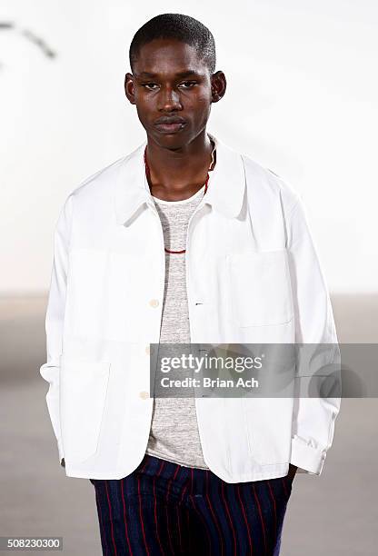 Model walks the runway during the Palmiers du Mal runway show during New York Fashion Week Men's Fall/Winter 2016 at Skylight at Clarkson Sq on...