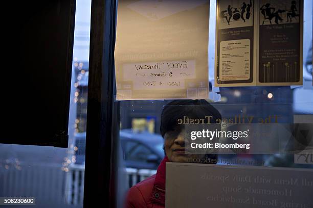 Woman looks in from the outside of the Village Trestle as Senator Ted Cruz, a Republican from Texas and 2016 presidential candidate, not pictured,...