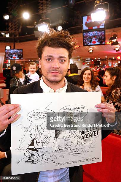 Youngest Main Guest of the Show, Actor and Humorist Kev Adams shows the Original Draw of Asterix that Uderzo did for him during the 'Vivement...